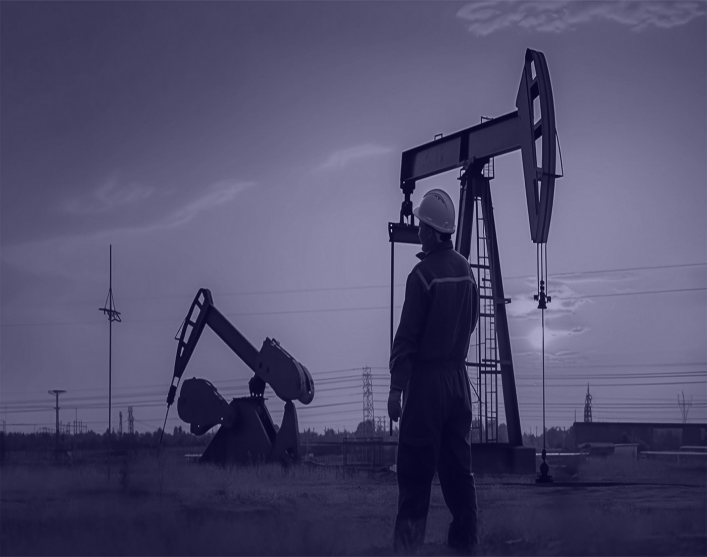 Worker at an oil rig during sunset